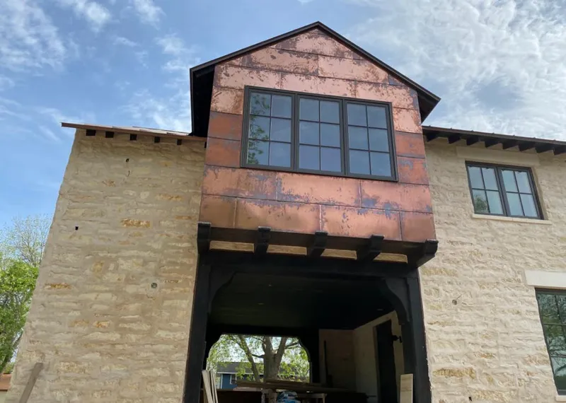 Copper metal panel facade on a stone building for Skylight Installation in Cherryville
