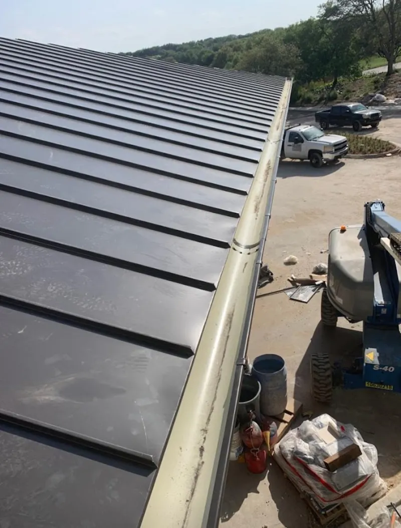 Standing seam panel and gutter detail on a metal roofing jobsite in Cherryville